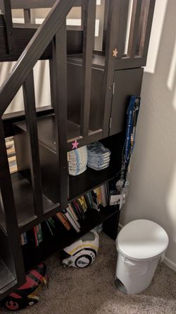 Bunk bed with stairs and small bookshelf