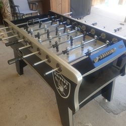 Football table with Raiders stickers on both sides