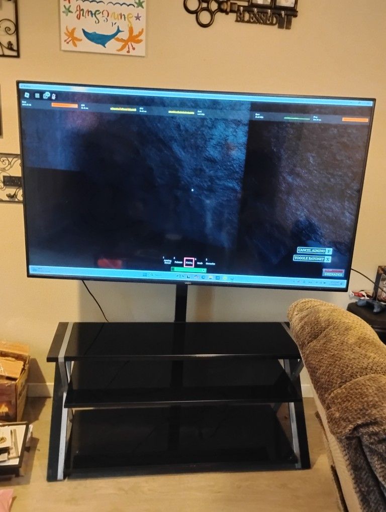 70 Inch TV With Swivable Entertainment Stand 