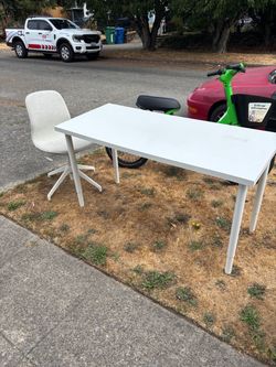 White desk table and swivel chair