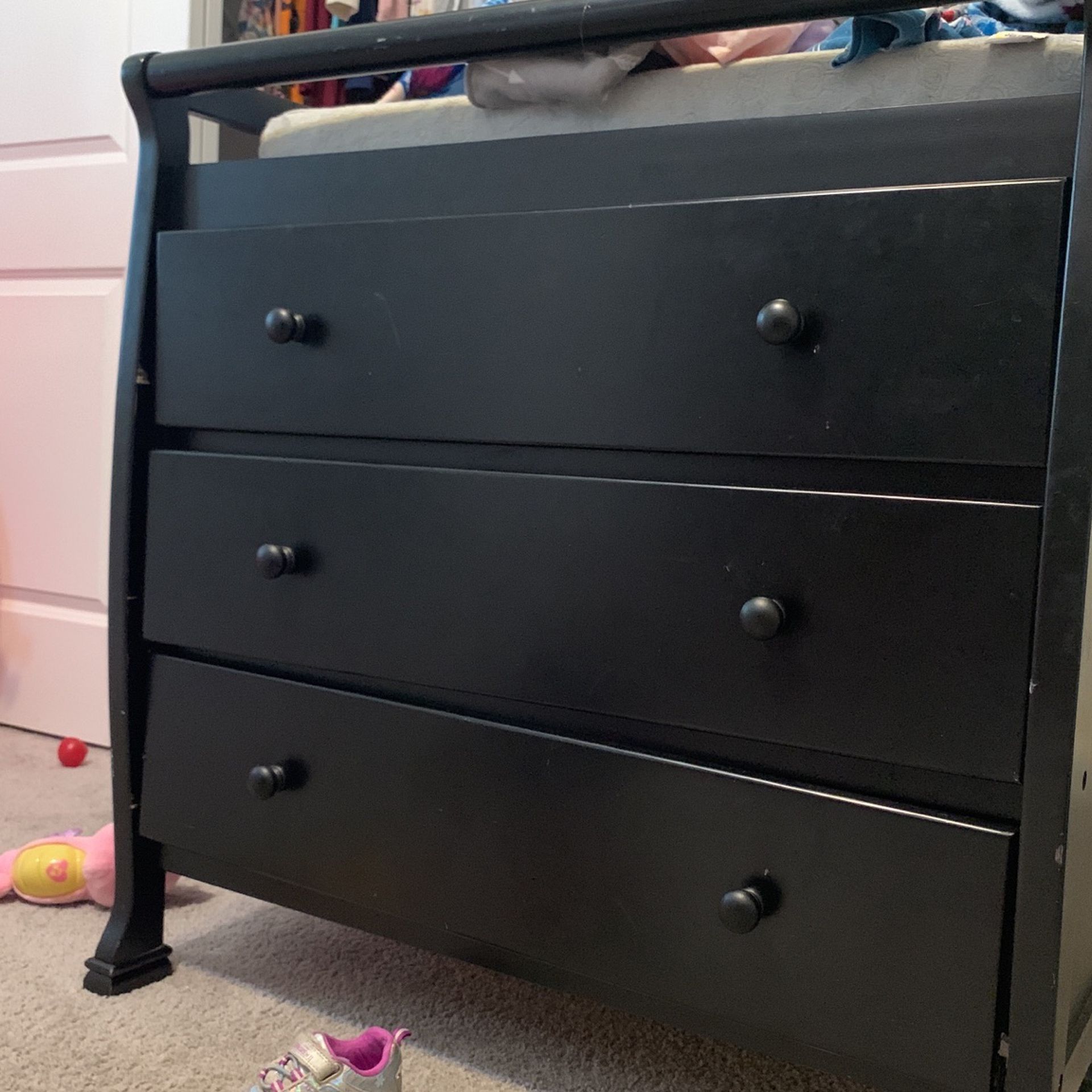 Changing Table With Black Crib That Converts Into A Full Size Bed.