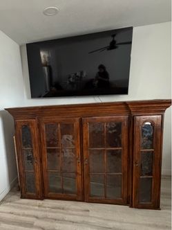 vintage glass-front sideboard or buffet cabinet.