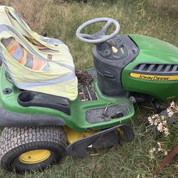 John Deere D130 riding lawnmower with towbehind cart