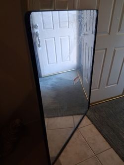 Large black metal framed bathroom wall mirror rounded corners.