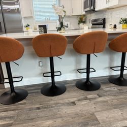 SET OF 4 ORANGE SWIVEL BAR STOOLS 