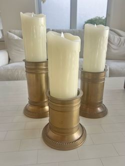 Beautiful 3 tiered candlestick holders with candles . Great for a coffee table or wall unit.