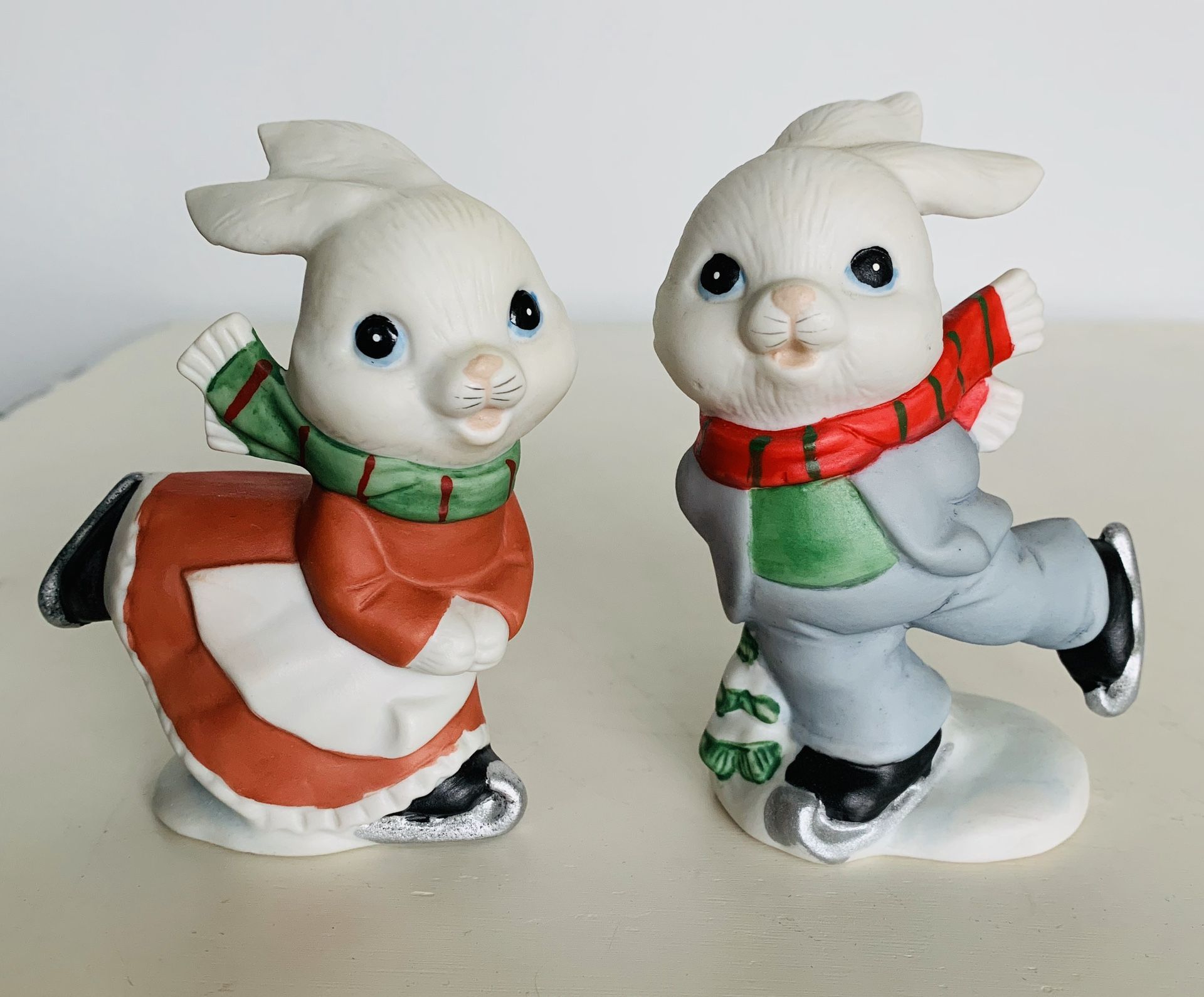 Vintage Homco christmas Ice skating Bunnies set of two. Porcelain/ceramic bisque. No chips cracks or damage. Paint Colors are bright. 4” tall.
