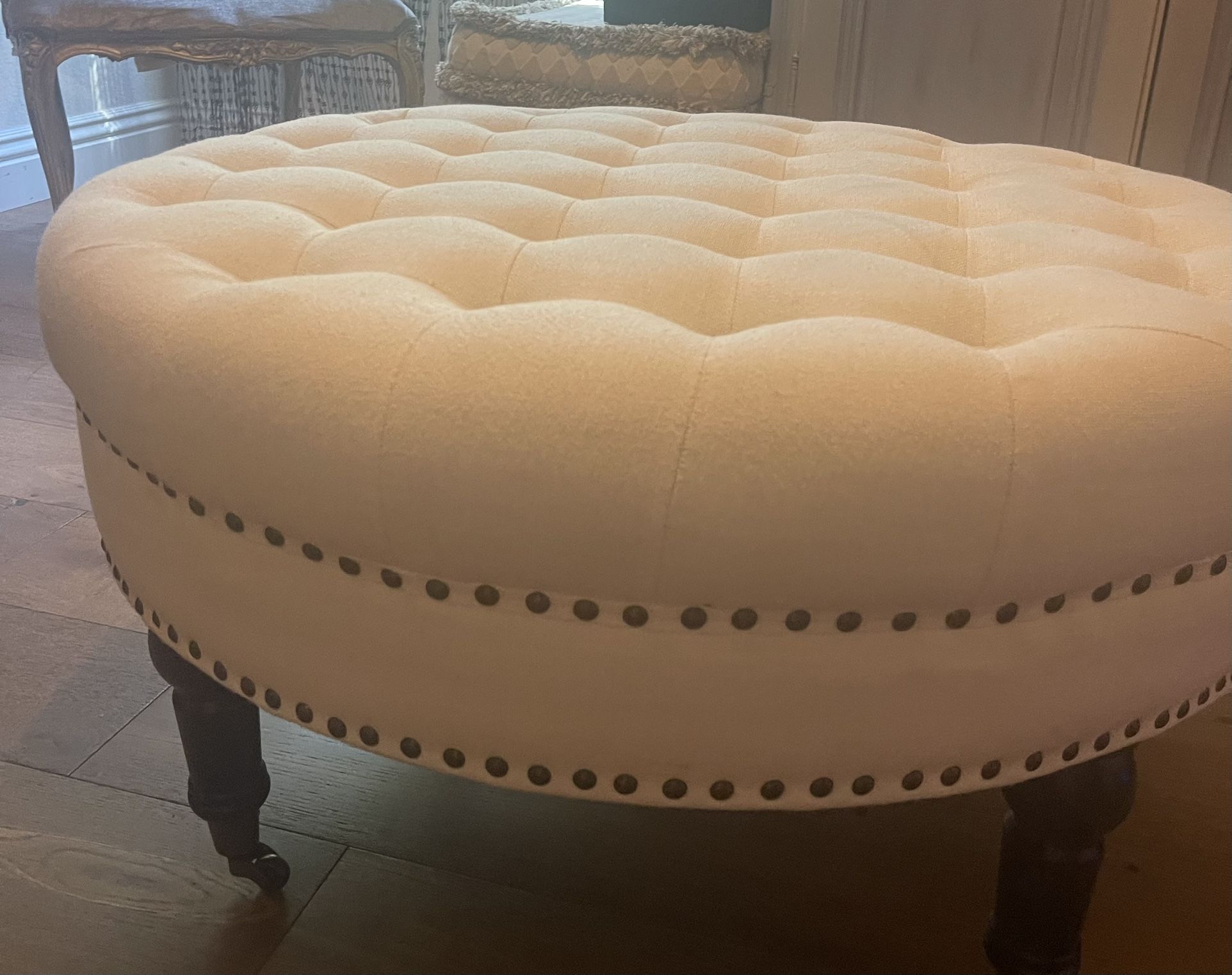 Ottoman with black wooden legs