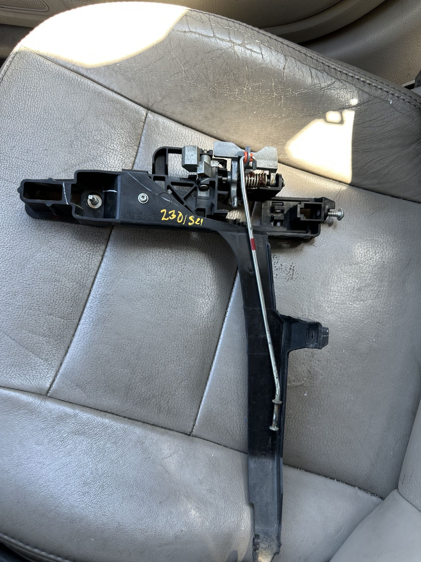 Used passenger side interior door handle bracket for a Ford Fusion (2006–2012).