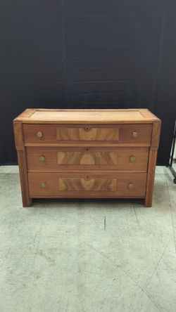 Warm Wood Three-Drawer Dresser with Ornate Hardware