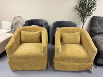 Brand new Stylish set of two accent armchairs. Each chair has 360-degree swivel. Upholstered in a vibrant mustard yellow textured fabric. Design is a 