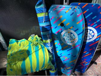 Boogie boards, beach umbrella and towel