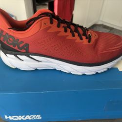Brand new Hoka Clifton 7 running shoes. Vibrant red color. Men's size 15.