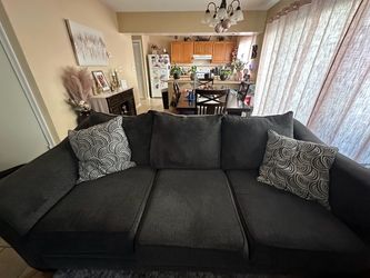 Gray couch w/ two pillows