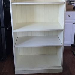Cream color solid bookshelf adjustable.