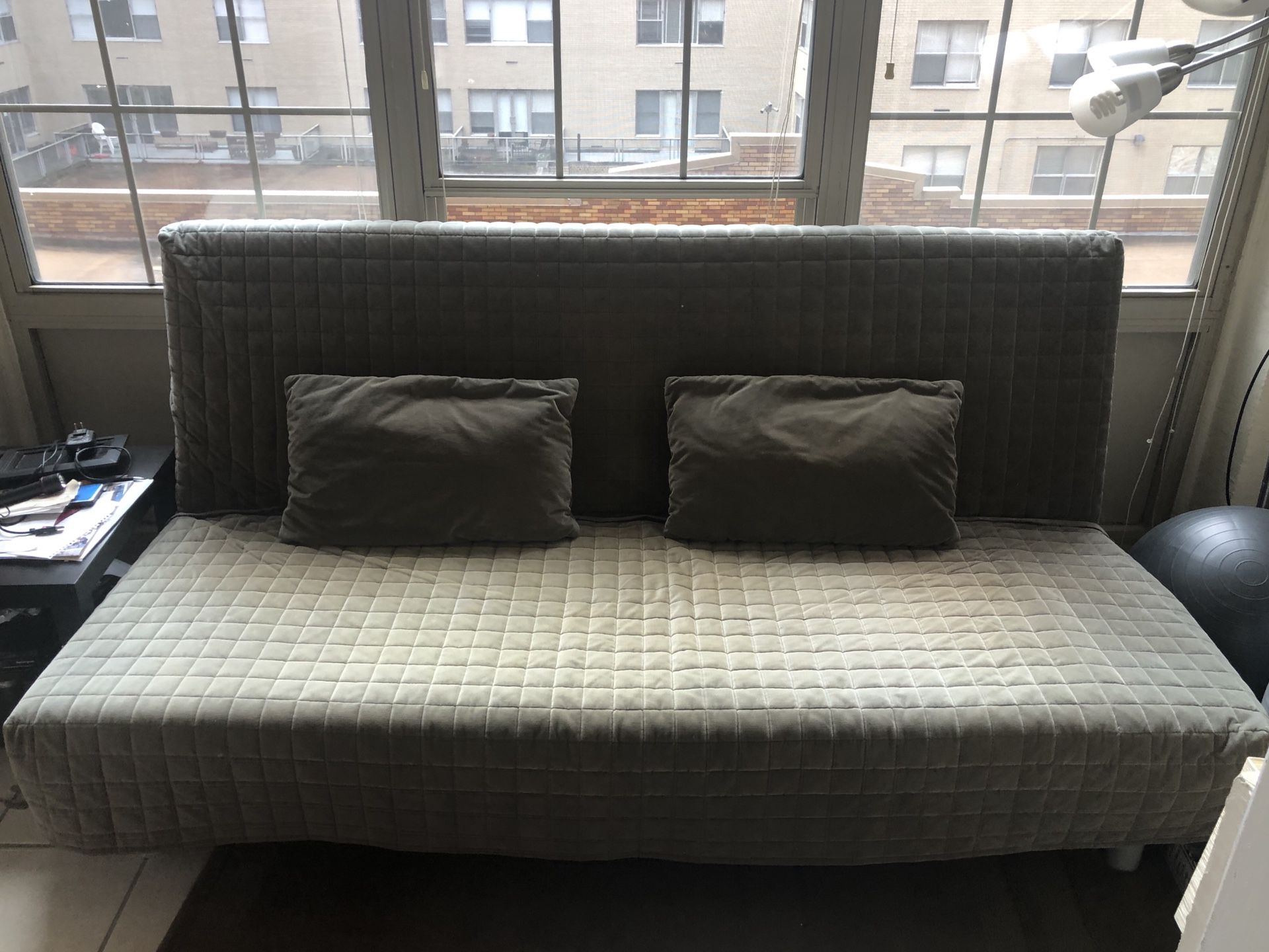 Futon with two slipcovers (1 pictured, 1 navy) and two pillows