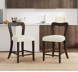 four armless mid-century style counter stools with slightly curved backrests and upholstered seats, featuring a dark brown finish and beige seats