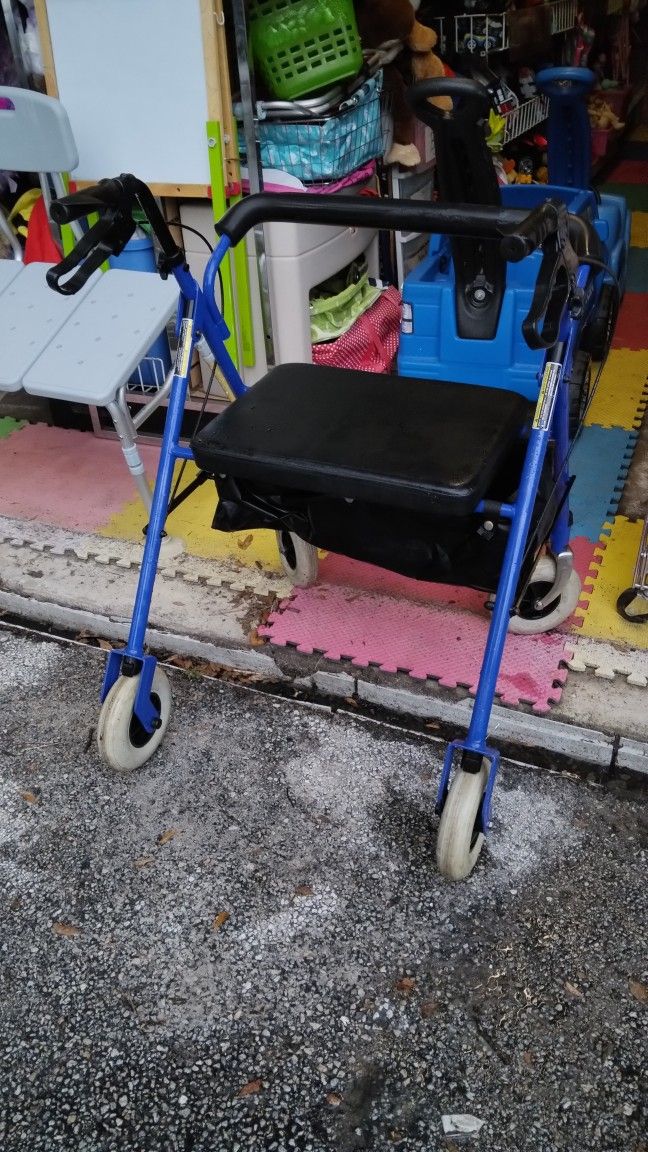 Seated Walker With Brakes Measures 22 In Wide In Seat Area And From Back Rest To End Of Handle Bar Is 18 In Out