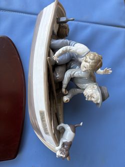 Lladro man and boy in boat with base