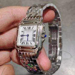 White and grey watch with blue hands