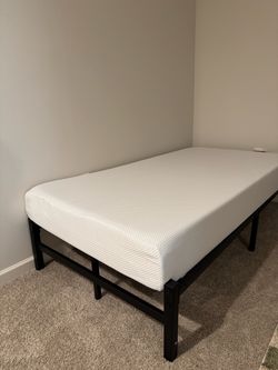 Twin bed (barely used mattress and frame)