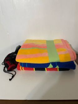 Three beach towels- one is a checkers game