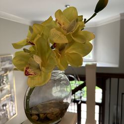 Yellow Artificial Flowers In fake Water With Rocks