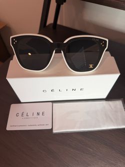 These luxury, Italian-made oversized cat-eye sunglasses feature a bold contrast design with an off-white outer frame and classic black inner rims, pai