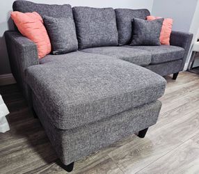 Like new! Excellent condition, 2-piece sectional sofa, dark gray. Features removable cushions and removable, washable covers; reversible design (chais