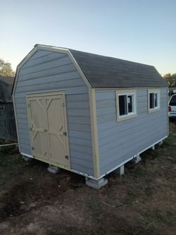 12x16 barn loft with 2 windows , double shed doors and 2 interior wood shelves  and a loft
