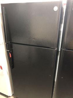 Used GE 16 cu ft top and bottom fridge. 1 year warranty