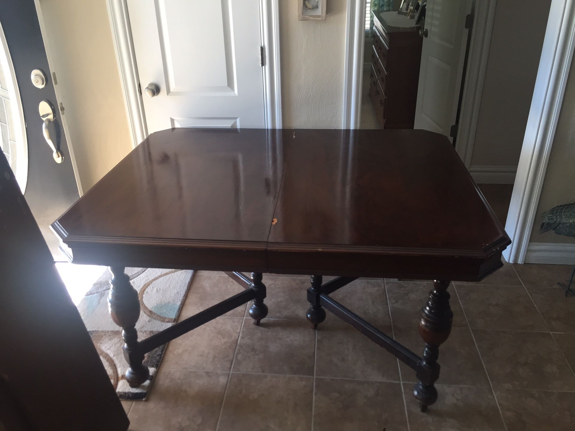 Antique dining table with 2 leafs and 5 chairs and 1 captains chair.