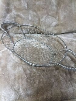 Vintage polished chrome oval chicken wire basket with handles. Brand new. Never used. 19" long with handles.
