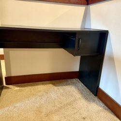 Black Desk With A Side Attached Shelf, Dimensions: 40.5 Inches In Length And 28 Inches In Height, Table Top Width Is 17.5 Inches