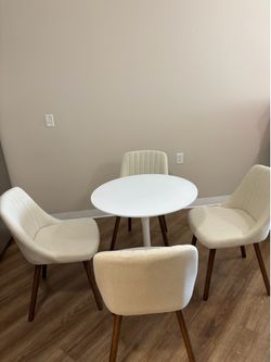 Four white upholstered chairs