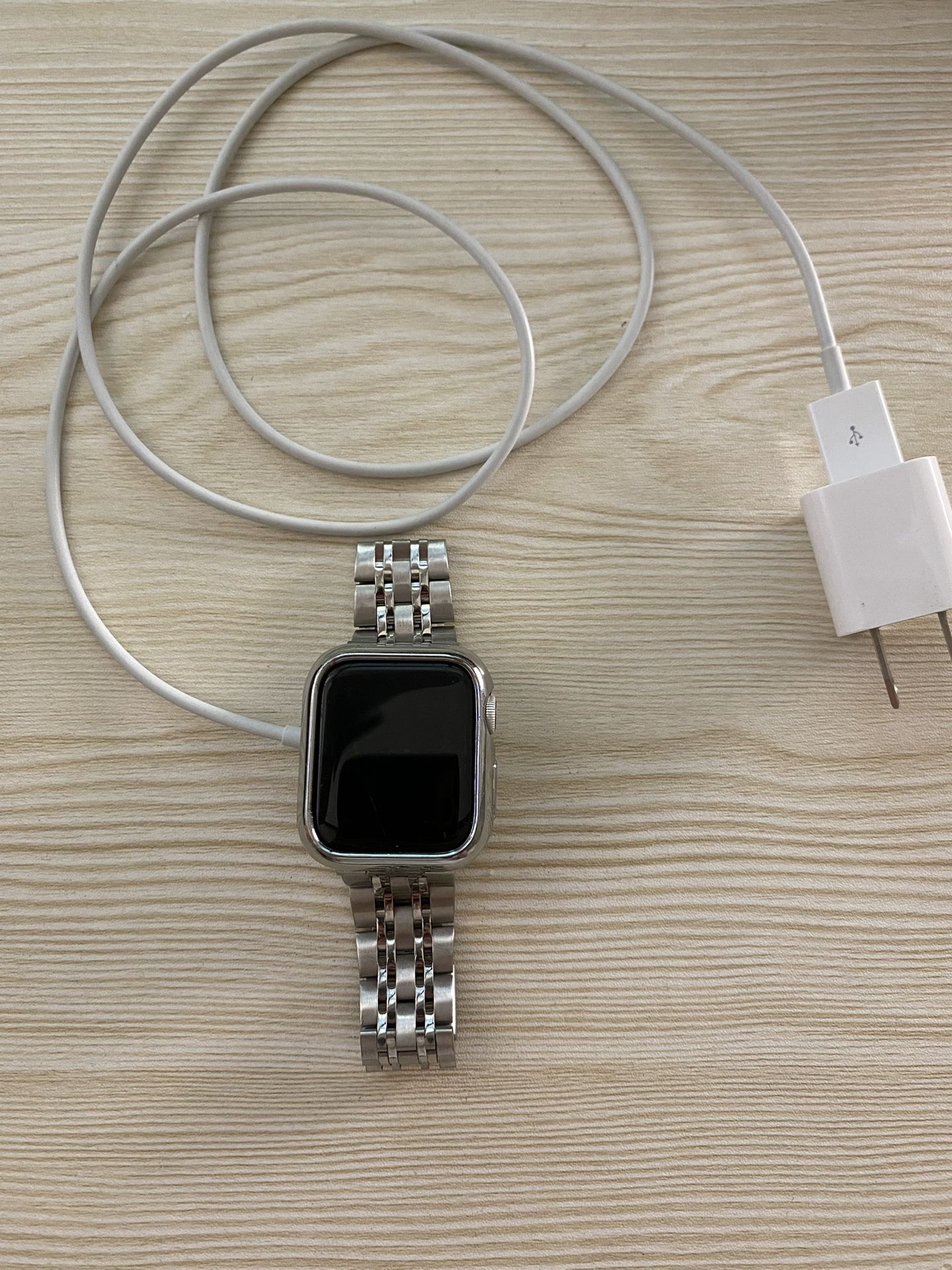 Apple Watch Series 4 40mm with charger, wall brick, and 3 straps
