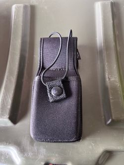 Duty radio holster, and two handcuff cases.