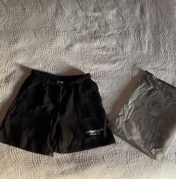 Essential shorts size large with white Lettering and long strings