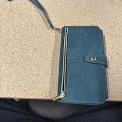 Stylish green wallet phone case with a zipper and wrist strap.