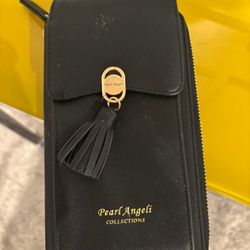 New black wallet that can be worn as a purse and it has a cell phone pocket as well