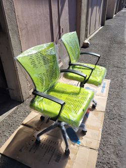 two neon-green mid-back ergonomic swivel mesh office chairs
