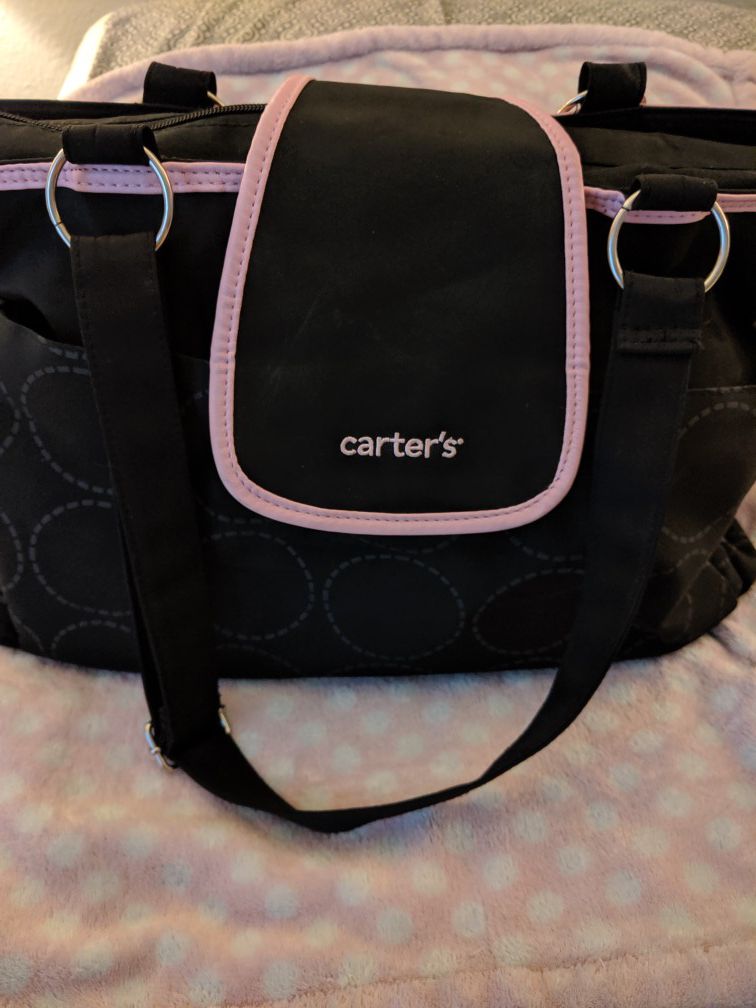 Carters black and pink diaper bag with pink baby blanket