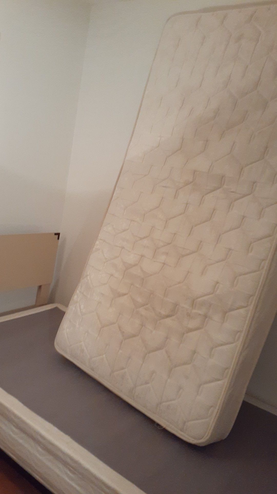 Bed with mattress and metal wheels