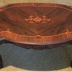 Beautiful antique coffee table...carved details and inlaid wood.....