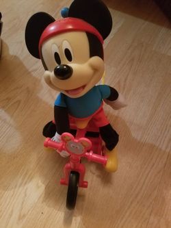 Walt Disney Micky mouse riding a bike