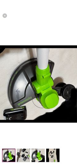 Greenworks cordless string trimmer in vibrant green and sleek gray. Perfect for efficient lawn care