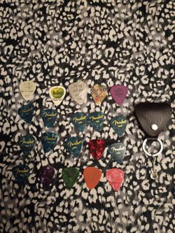 Mixed lot of guitar picks and a pick holder all for $10