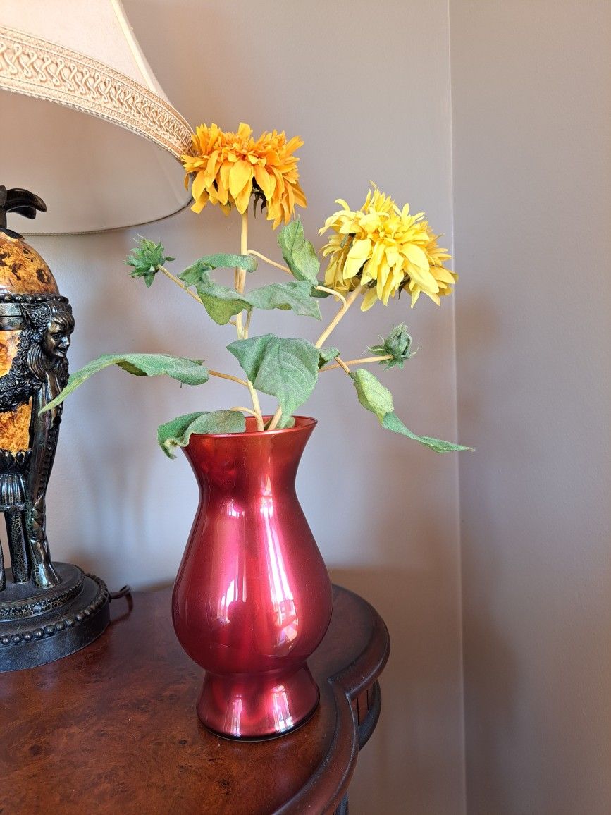 Red glass vase with flowers included, vase is 8 1/2 in tall