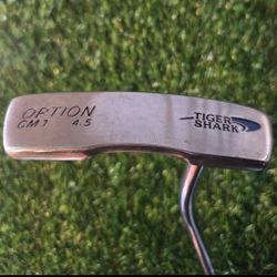 Tiger Shark Option CM1 golf putter. 
It is a blade-style putter. 
The model number is CM1, with a loft specified as 4.5. 
It is a right-handed club. 