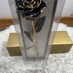This is a real purple rose that has been preserved in lacquer and trimmed in 24k gold.